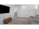 Comfortable living room with a view of the staircase and access to another room at 514 Cunninghame Ct, Peachtree City, GA 30269