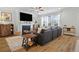 Comfortable living room with fireplace, mounted television, wood-look flooring and lots of natural light at 514 Cunninghame Ct, Peachtree City, GA 30269