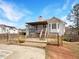 Backyard view of wood deck, stairs to yard, bay window, light posts and partial fence at 5281 Brookshire Ct, Douglasville, GA 30135