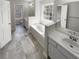 Well-lit bathroom with a soaking tub, double sinks, and modern fixtures at 5281 Brookshire Ct, Douglasville, GA 30135