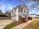 Side view of the house featuring a two-car garage and mature landscaping at 5281 Brookshire Ct, Douglasville, GA 30135