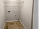 Compact laundry room with wire shelving and tan floors at 5281 Brookshire Ct, Douglasville, GA 30135