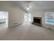 Cozy living room with a fireplace, bright windows, and views of the backyard pool at 5281 Brookshire Ct, Douglasville, GA 30135
