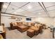Finished basement with carpet, painted brick, and modular ceiling with large sectional couch at 6325 S Summers S Cir, Douglasville, GA 30135
