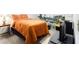 Bedroom with an orange bedspread, carpeted floors, and a detailed picture on the wall at 6325 S Summers S Cir, Douglasville, GA 30135