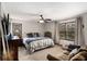 Cozy carpeted bedroom features a ceiling fan, two windows, and comfortable seating area at 6325 S Summers S Cir, Douglasville, GA 30135