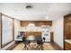 Basement kitchen with wooden cabinets, white appliances, and a table for two at 6325 S Summers S Cir, Douglasville, GA 30135