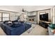 Comfortable living room with a fireplace, and a large blue sectional sofa at 6325 S Summers S Cir, Douglasville, GA 30135