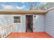 A covered back porch with a secure door and grill-covered window offers a private outdoor space at 16 Wadley Nw St, Atlanta, GA 30314