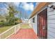Outdoor deck with red painted planks, secure door and view of the fenced yard at 16 Wadley Nw St, Atlanta, GA 30314