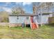 Home's backyard features a small deck with stairs and a grassy lawn at 16 Wadley Nw St, Atlanta, GA 30314