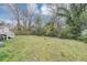 Spacious backyard features a large grassy area, mature trees, and a wooden fence at 16 Wadley Nw St, Atlanta, GA 30314