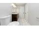 Well-lit bathroom with tile floors featuring vanity, mirror, and toilet for essential needs at 16 Wadley Nw St, Atlanta, GA 30314