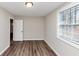 Bedroom with wood floor and natural light streaming through a window with white blinds at 16 Wadley Nw St, Atlanta, GA 30314
