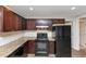 Kitchen featuring brown cabinets, granite countertop, stainless steel appliances, and modern lighting at 16 Wadley Nw St, Atlanta, GA 30314