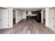 Open-concept living space with modern flooring, a view of the kitchen, and neutral paint at 16 Wadley Nw St, Atlanta, GA 30314