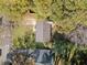 An aerial shot of the home, nestled amongst mature trees on a well-maintained lot with lush green grass at 1824 Evans Sw Dr, Atlanta, GA 30310