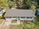 An aerial view of the charming home showcasing the metal roof, manicured lawn, and landscaped flower beds at 1824 Evans Sw Dr, Atlanta, GA 30310
