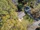 A top-down aerial view shows the home surrounded by a lush, green canopy of mature trees in its neighborhood at 1824 Evans Sw Dr, Atlanta, GA 30310