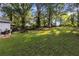 Spacious backyard with lush green grass, a picnic table and patio seating at 1824 Evans Sw Dr, Atlanta, GA 30310