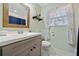Bathroom featuring a toilet, vanity, mirror, shelving, and a window for natural light at 1824 Evans Sw Dr, Atlanta, GA 30310