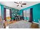 Bedroom with a ceiling fan, lots of wall art, and two windows for plenty of light at 1824 Evans Sw Dr, Atlanta, GA 30310
