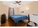 Cozy bedroom with hardwood floors, ceiling fan, closet and a large window for natural light at 1824 Evans Sw Dr, Atlanta, GA 30310
