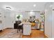 Bright kitchen featuring white cabinets, stainless steel appliances, a breakfast bar, and hardwood floors at 1824 Evans Sw Dr, Atlanta, GA 30310