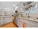 Well-lit kitchen with stainless steel appliances, granite countertops, hardwood floors, and ample cabinet space at 1824 Evans Sw Dr, Atlanta, GA 30310