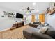 Comfortable living room with a sectional sofa, wooden floors, and modern shelving, ideal for relaxation and entertainment at 1824 Evans Sw Dr, Atlanta, GA 30310