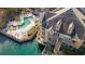 Aerial view of a lakeside condo with private balconies, a pool, and surrounding greenery at 504 Mill Pond Ct, Smyrna, GA 30082