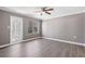 A cozy bedroom featuring new vinyl flooring, ceiling fan, and fresh, neutral-colored paint at 504 Mill Pond Ct, Smyrna, GA 30082