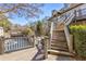 Inviting multi-level deck with stairs overlooking lush greenery and a serene water feature at 504 Mill Pond Ct, Smyrna, GA 30082