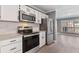 Contemporary kitchen featuring stainless steel appliances, granite countertops, and bright white cabinets at 504 Mill Pond Ct, Smyrna, GA 30082