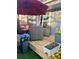 Back deck features a cozy outdoor seating area with a dining table and a colorful garden at 1044 Mariners Ct, Stone Mountain, GA 30083