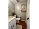 Bathroom featuring a sink, toilet, and rustic mirror decor at 1044 Mariners Ct, Stone Mountain, GA 30083