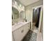Bathroom featuring an updated vanity, modern mirrors, matte black hardware, and separate shower at 1044 Mariners Ct, Stone Mountain, GA 30083