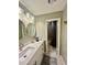 Updated bathroom with double sink vanity, modern mirrors, matte black hardware, and separate shower at 1044 Mariners Ct, Stone Mountain, GA 30083