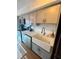 Bright kitchen featuring white cabinets, farmhouse sink, and modern faucet at 1044 Mariners Ct, Stone Mountain, GA 30083