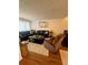 Cozy living room featuring a plush sofa, recliner, and decorative art at 1044 Mariners Ct, Stone Mountain, GA 30083