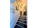 Staircase with decorative artwork and a stylish runner at 1044 Mariners Ct, Stone Mountain, GA 30083