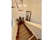Bright and airy staircase with wood treads, carpet runner, chandelier, and decor at 1044 Mariners Ct, Stone Mountain, GA 30083