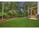 View of backyard with lawn and wooden deck with stairs at 1920 Rocky Mill Ln, Lawrenceville, GA 30044