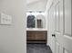 Bathroom with double vanity, dark hexagon tile, and arched mirrors at 1920 Rocky Mill Ln, Lawrenceville, GA 30044
