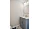 Stylish powder room features decorative tile flooring, a round mirror, and gold hardware at 1920 Rocky Mill Ln, Lawrenceville, GA 30044