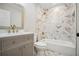 Beautiful bathroom with herringbone-patterned tile, shower with tub, and gold fixtures at 1920 Rocky Mill Ln, Lawrenceville, GA 30044