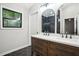 Bathroom with double vanity, arched mirrors, and a view of the shower at 1920 Rocky Mill Ln, Lawrenceville, GA 30044
