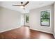 Spacious bedroom featuring hardwood floors, a ceiling fan, and natural light from two windows at 1920 Rocky Mill Ln, Lawrenceville, GA 30044