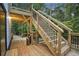 Wooden deck with black metal railings and stairs leading down to the yard at 1920 Rocky Mill Ln, Lawrenceville, GA 30044