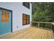 A close-up of the wooden deck with black metal railings and a light blue door at 1920 Rocky Mill Ln, Lawrenceville, GA 30044